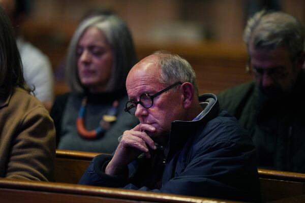 Dennis Downey, center, sits in meditation at St. James Episcopal Church's weekly "Contemplative Citizenship" service in Lancaster, Pa., on Tuesday, Oct. 15, 2024. (AP Photo/Jessie Wardarski)