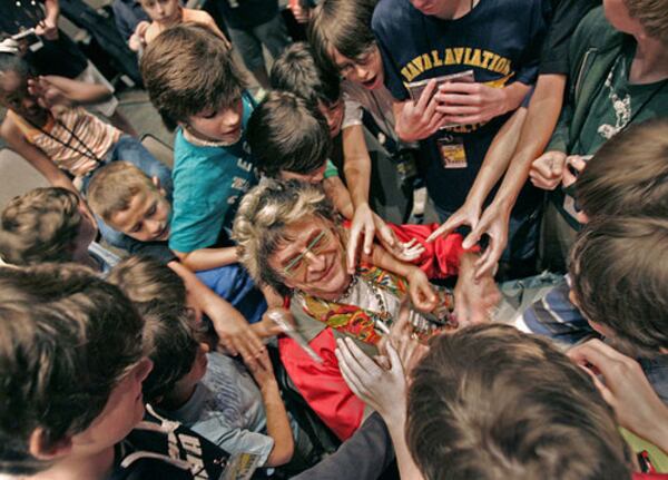 Camp Jam students gather around instructor Jim Peterik on Tuesday at the Greenfield Hebrew Academy in Atlanta, home for a summer rock and roll camp. Peterik is best known for writing the rock anthem "Eye of the Tiger" for the "Rocky III" movie while with the band Survivor.