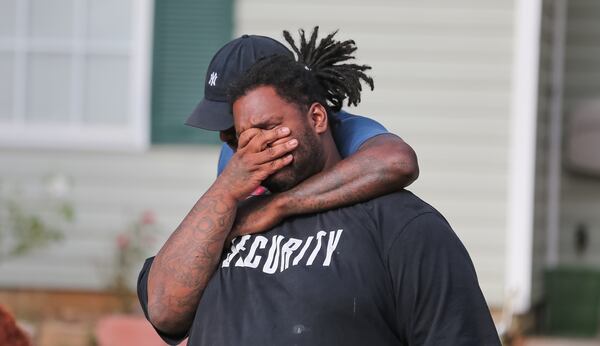 Anthony Lewis grieves the death of his brother, an 11th-grade student at Charles Drew High School in Clayton County. JOHN SPINK / JSPINK@AJC.COM