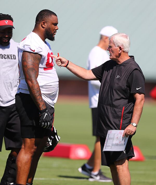 Falcons senior assistant Bob Sutton works with defensive tackle Ra'Shede Hageman during the third practice of training camp Wednesday, July 24, 2019, in Flowery Branch.