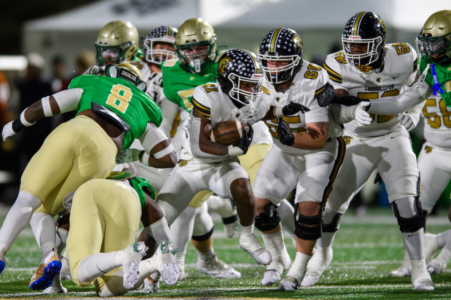 Carrollton's Kimauri Farmer squeezes past the Buford defense. (Jamie Spaar for the Atlanta Journal Constitution)