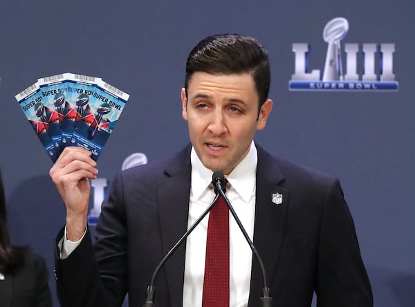 Michael Buchwald, NFL Senior Counsel, Legal, holds up real Super Bowl tickets during the National Football League and law enforcement agencies press conference announcing the latest results of seizures of counterfeit game-related merchandise and tickets during a press conference at the Georgia World Congress Center on Thursday, Jan. 31, 2019, in Atlanta.   Curtis Compton/ccompton@ajc.com