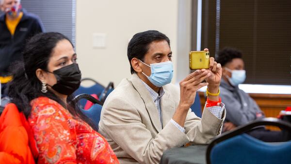 Vinayak Menon's parents, Aswathy Gangadharan (left) and Ravi Menon video his speech during the Voices for Prevention Substance Abuse Prevention Day at the Georgia Capitol event in Atlanta. PHIL SKINNER FOR THE ATLANTA JOURNAL-CONSTITUTION.