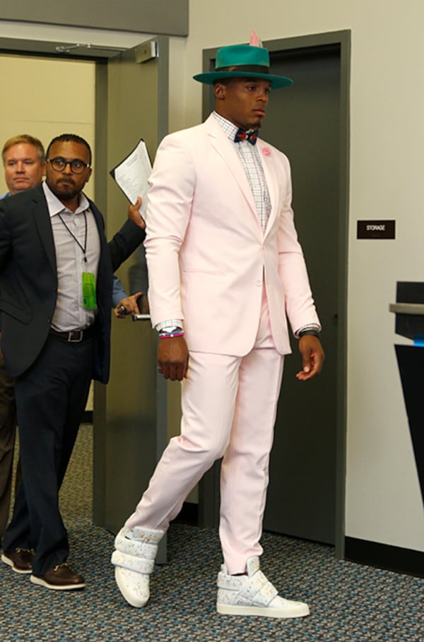 Carolina Panthers' Cam Newton enters the interview room after win against the Arizona Cardinals in Charlotte, N.C.