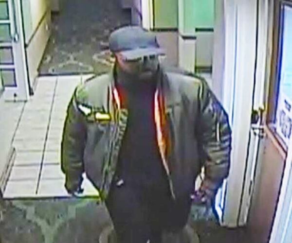 DeKalb County police say this man is a person of interest after a woman was strangled to death in a hotel room.