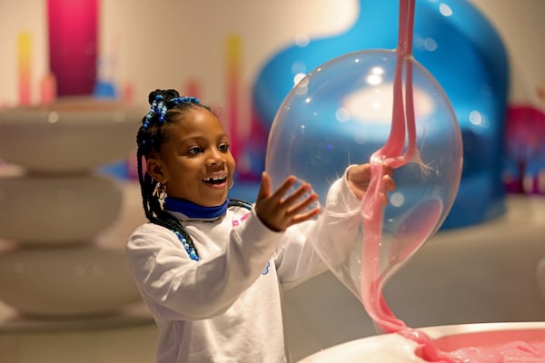 Londyn White, 6, of Atlanta, plays with a slime bubble created by a Sloomoo employee at Sloomoo in Buckhead, Wednesday, November 16, 2022, in Atlanta. Jason Getz / Jason.Getz@ajc.com)