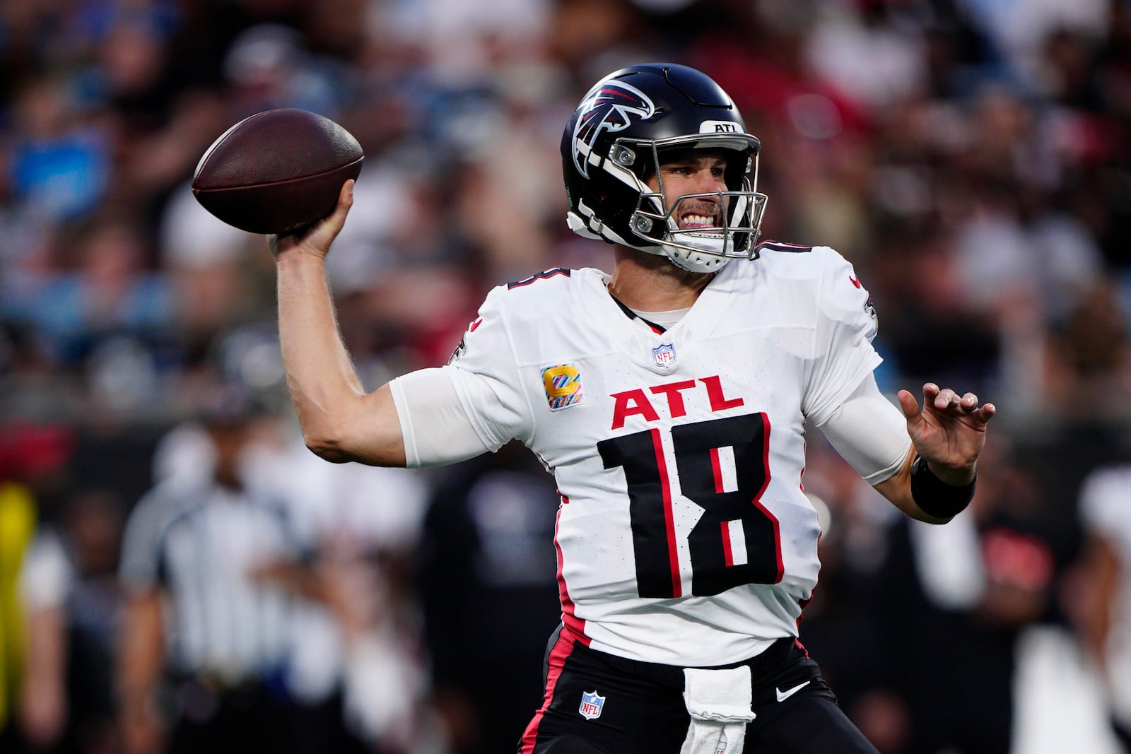 Atlanta Falcons quarterback Kirk Cousins (18) sets back to pass in the second half of an NFL football game against the Carolina Panthers in Charlotte, N.C., Sunday, Oct. 13, 2024. (AP Photo/Jacob Kupferman)