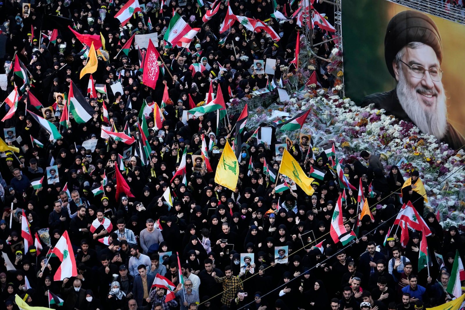 FILE - Mourners attend a rally commemorating slain Hezbollah leader Hassan Nasrallah, shown in billboard, at Felestin (Palestine) Sq. in downtown Tehran, Iran, Monday, Sept. 30, 2024. (AP Photo/Vahid Salemi, File)