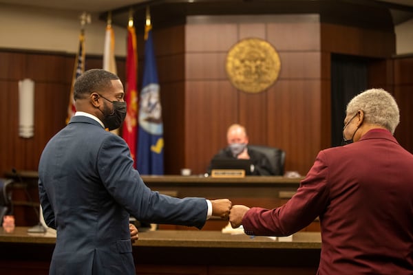 01/22/2021 —Marietta, Georgia — U.S. Military Veterans Kenneth (left) and Edward (right) congratulate each other with a fist-bump after they both graduated from the Veterans Accountability and Treatment Court in Cobb Superior Court at the Cobb County Superior Courthouse, Friday, January 22, 2021. (Alyssa Pointer / Alyssa.Pointer@ajc.com) [Last names are withheld by request of judge.]