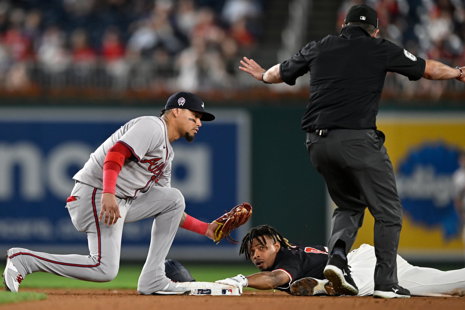 Atlanta Braves shortstop Orlando Arcia, left, is late with the tag as Washington Nationals' Jose Tena steals second base during the eighth inning of a baseball game, Wednesday, Sept. 11, 2024, in Washington. (AP Photo/John McDonnell)