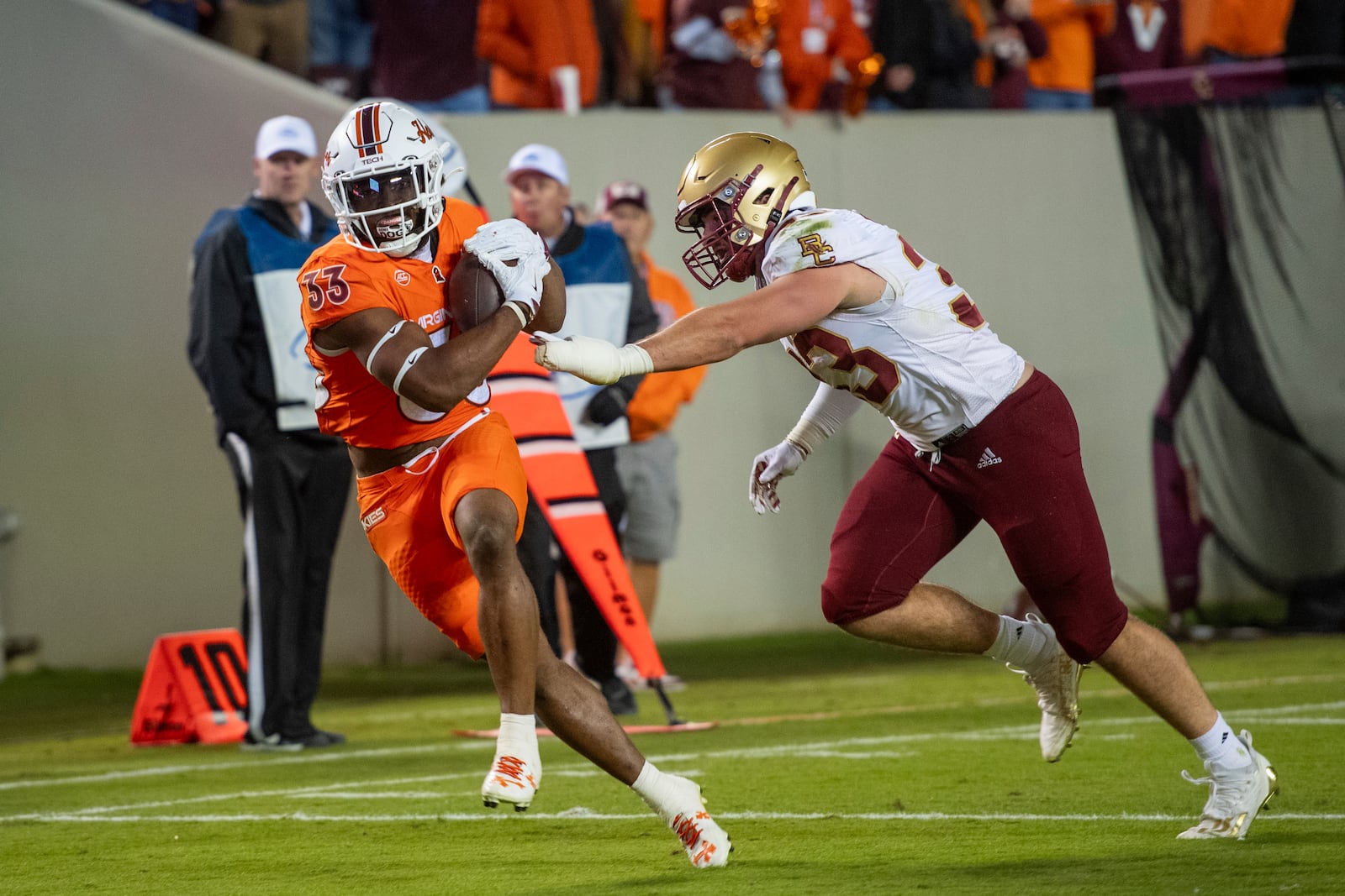 Virginia Tech's Bhayshul Tuten, left, runs for a long touchdown while defended by Boston College's Owen McGowan, right, during the first half of an NCAA college football game Thursday, Oct. 17, 2024, in Blacksburg, Va. (AP Photo/Robert Simmons)