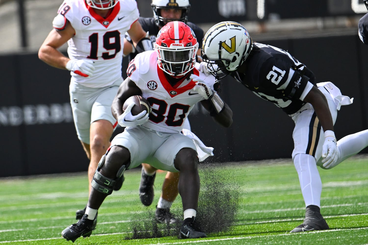 Georgia running back Daijun Edwards (30) runs against Vanderbilt safety Savion Riley (21) during the first quarter of an NCAA football game, Saturday, Oct. 14, 2023, in Nashville, Tenn. (Special to the AJC/John Amis)