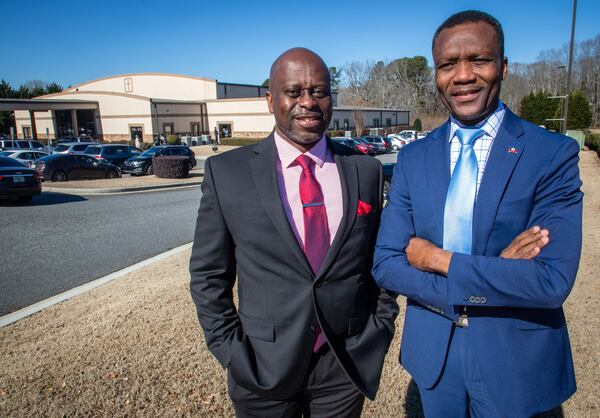  Watson Escarment (L)  and Claude-Henry Pierre pose for a photograph outside the Good Samaritan Haitian Alliance Church  Lawrenceville Sunday, February 6, 2022.   STEVE SCHAEFER FOR THE ATLANTA JOURNAL-CONSTITUTION