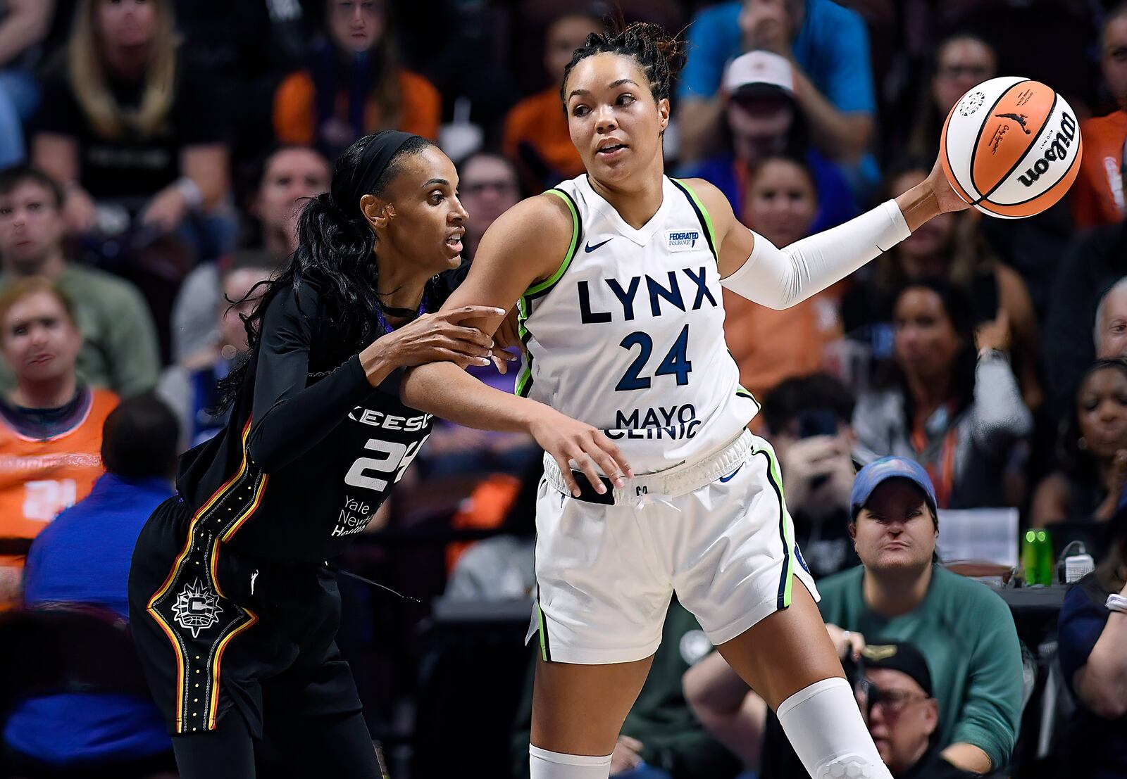 Connecticut Sun forward DeWanna Bonner (24) guards Minnesota Lynx forward Napheesa Collier (24) during the second half of Game 4 in the WNBA basketball semifinals, Sunday, Oct. 6, 2024, in Uncasville, Conn. (AP Photo/Jessica Hill)