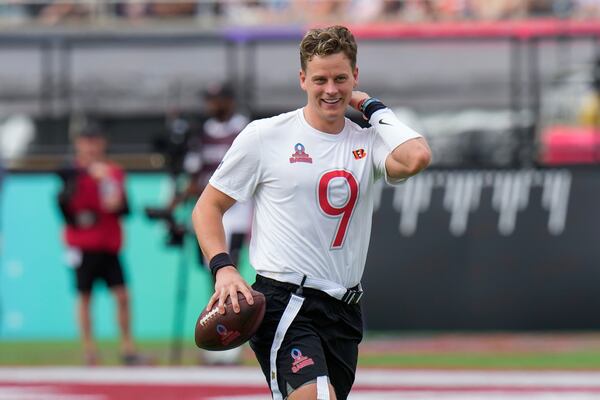 FILE - AFC quarterback Joe Burrow, of the Cincinnati Bengals, smiles after he was sacked during the flag football event at the NFL Pro Bowl, in Orlando, Feb. 2, 2025. (AP Photo/Chris O'Meara)