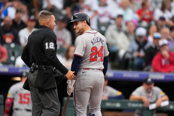 Atlanta Braves' Jarred Kelenic, right, argues after he was called out on strikes by home plate umpire Jonathan Parra in the second inning of a baseball game against the Colorado Rockies, Friday, Aug. 9, 2024, in Denver. (AP Photo/David Zalubowski)