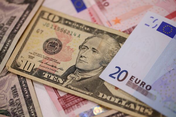 A U.S. ten dollar bills sits among ten and twenty euro banknotes in this arranged photograph taken inside a Travelex store, operated by Travelex Holdings Ltd., in London, U.K., on Monday, Jan. 12, 2015. Photographer: Simon Dawson/Bloomberg