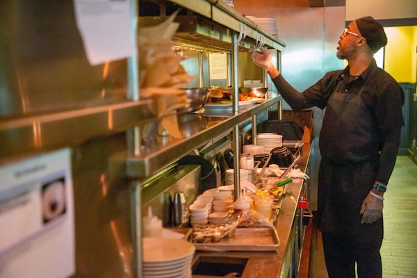 Marlow's Tavern Sous Chef Erice Ford works on both meals and to-go orders during their lunch rush Friday, March 11, 2022.   STEVE SCHAEFER FOR THE ATLANTA JOURNAL-CONSTITUTION