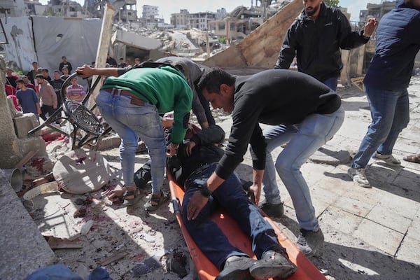 Palestinians evacuate an injured man after his house was hit by an Israeli bombardment in Gaza City, Wednesday, March 19, 2025. (AP Photo/Jehad Alshrafi)