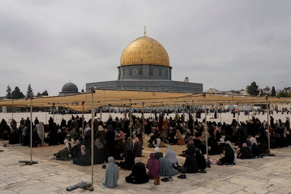 Palestinian women sit under the shade before Friday prayers at the Al-Aqsa Mosque compound in the Old City of Jerusalem, during the Muslim holy month of Ramadan, Friday, March 14, 2025. (AP Photo/Mahmoud Illean)