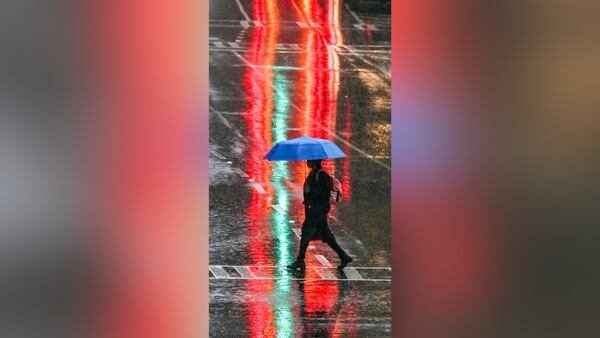 Tail lights from vehicles on Martin Luther King Jr. Drive near Central Avenue in downtown Atlanta made for a colorful wallpaper for a pedestrian passing by on the way to work on Friday morning.