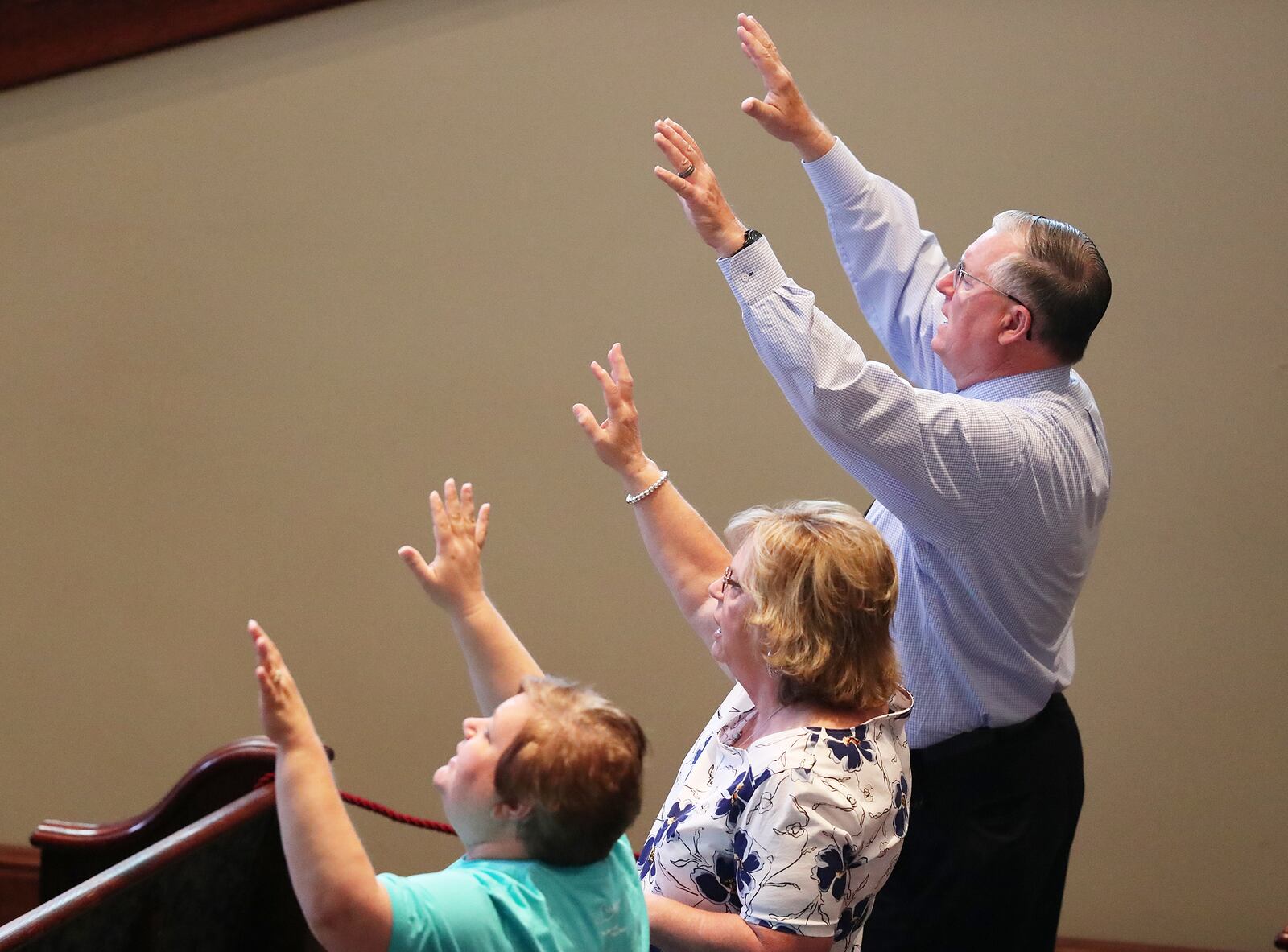 Linny Dew, right, who was hospitalized with COVID-19, and his wife Carlotta, center, worshiped at the Church at Liberty Square in Cartersville on June 7, the first time the church reopened its sanctuary to Sunday services after shutting down amid the pandemic. Earlier in the year, a COVID-19 outbreak at the church sickened at least 75 worshipers and killed four. Curtis Compton ccompton@ajc.com