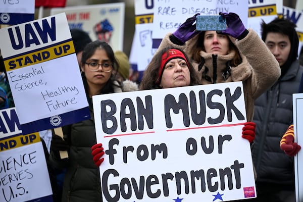 People rally at Health and Human Services headquarters to protest the polices of President Donald Trump and Elon Musk Wednesday, Feb. 19, 2025, in Washington. (AP Photo/John McDonnell)