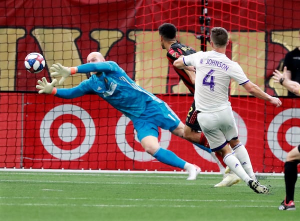 Atlanta United goalkeeper Brad Guzan blocks a shot by Orlando City defender Will Johnson Sunday, May 12, 2019, in Atlanta. 