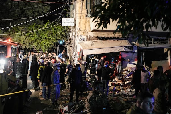 Residents and rescuers gather at the site of an Israeli airstrike in Beirut, Lebanon, Monday, Nov. 18, 2024. (AP Photo/Bilal Hussein)