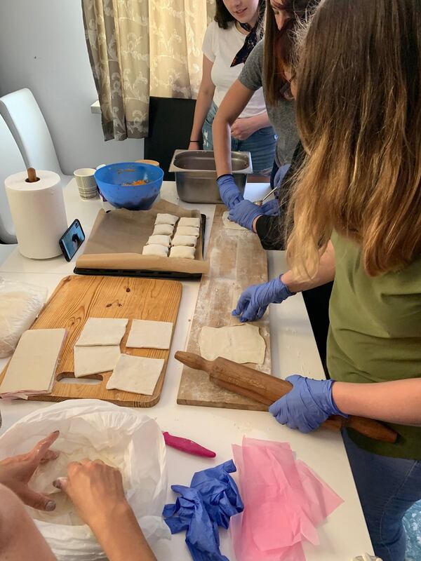 In a small apartment just south of Warsaw’s downtown, the Habitat for Humanity group joined a family from Kyrgyzstan to prepare a home-cooked meal. The dining room table became an assembly line of sorts — the place where dumplings could be filled and folded. MARK A. WALIGORE / MARK.WALIGORE@AJC.COM