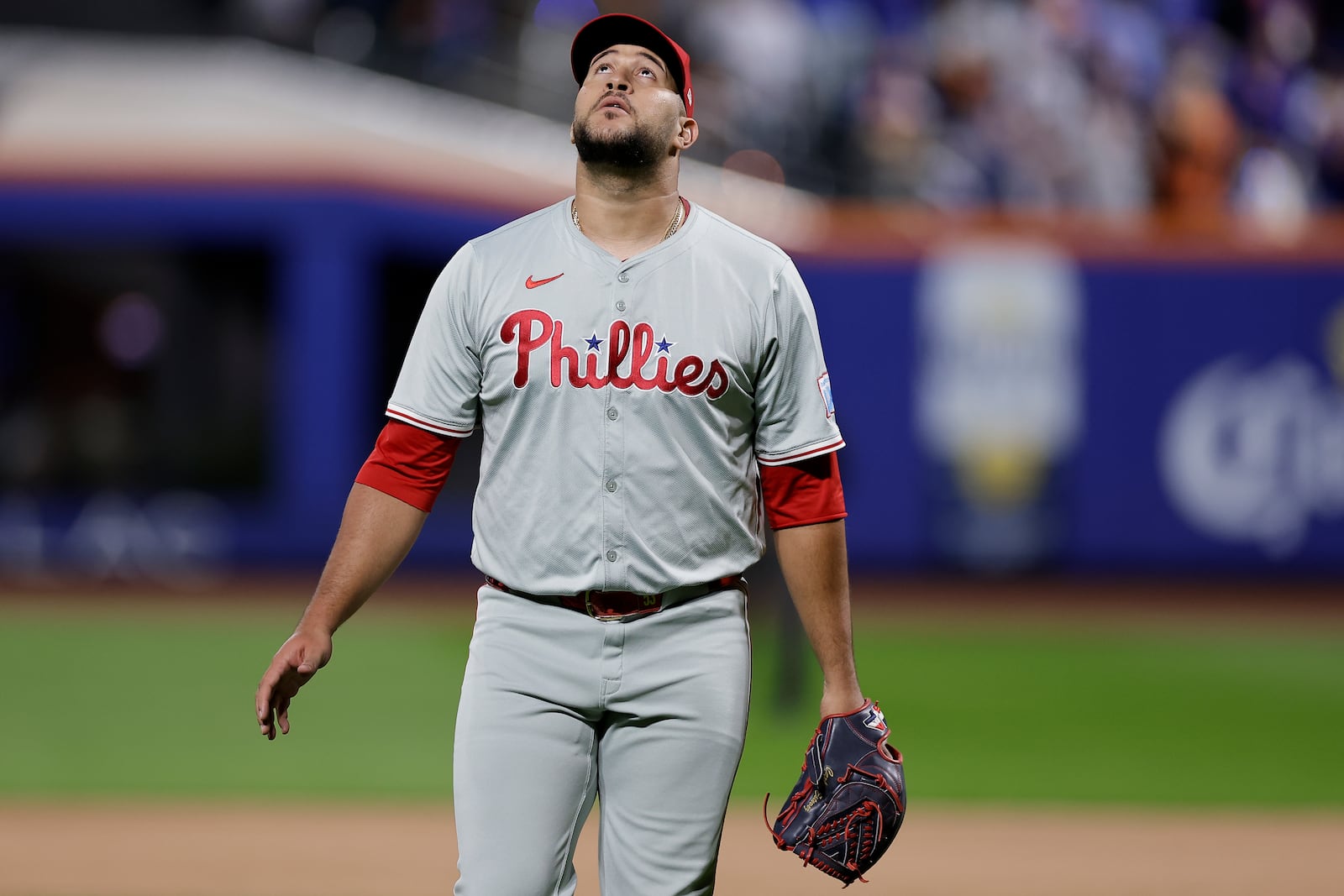 Philadelphia Phillies hitting coach Kevin Long (53) walks off the field at the end of the sixth inning after giving up a grand slam home run to the New York Mets during Game 4 of the National League baseball playoff series, Wednesday, Oct. 9, 2024, in New York. (AP Photo/Adam Hunger)