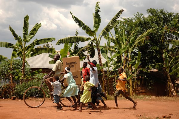 A family in Jinja, Uganda, brings home donations received through Operation Christmas Child overseen by the Samaritan’s Purse. Courtesy photo