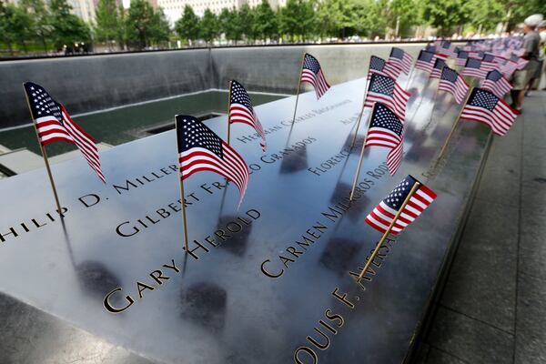 American flags are inserted in each of the names on the 9/11 Memorial in New York.