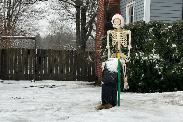 A Christmas display is covered in snow in Portland, Maine, on Wednesday, Dec. 11, 2024. (AP Photo/Patrick Whittle)