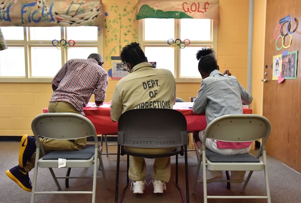 An imprisoned mom plays with her children in the Children's Center at Pulaski State Prison in Hawkinsville on Saturday, Aug. 13, 2016. (Hyosub Shin / AJC)