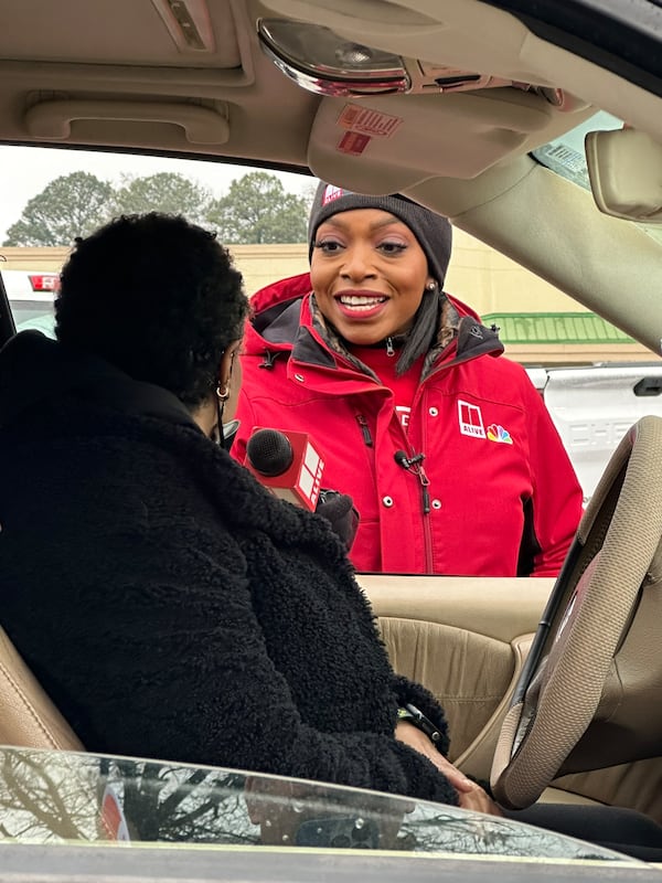 11Alive anchor Aisha Howard interviews a donor at the annual Can-a-thon for The Salvation Army on Dec. 1, 2023. RODNEY HO/rhO@ajc.com