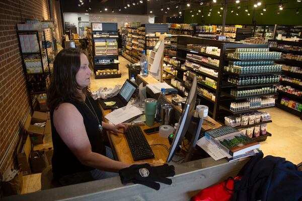 Owner Mari Geier works on inputting inventory at her new store, Nuts 'n Berries in Decatur, Tuesday, May 28, 2020. STEVE SCHAEFER FOR THE ATLANTA JOURNAL-CONSTITUTION