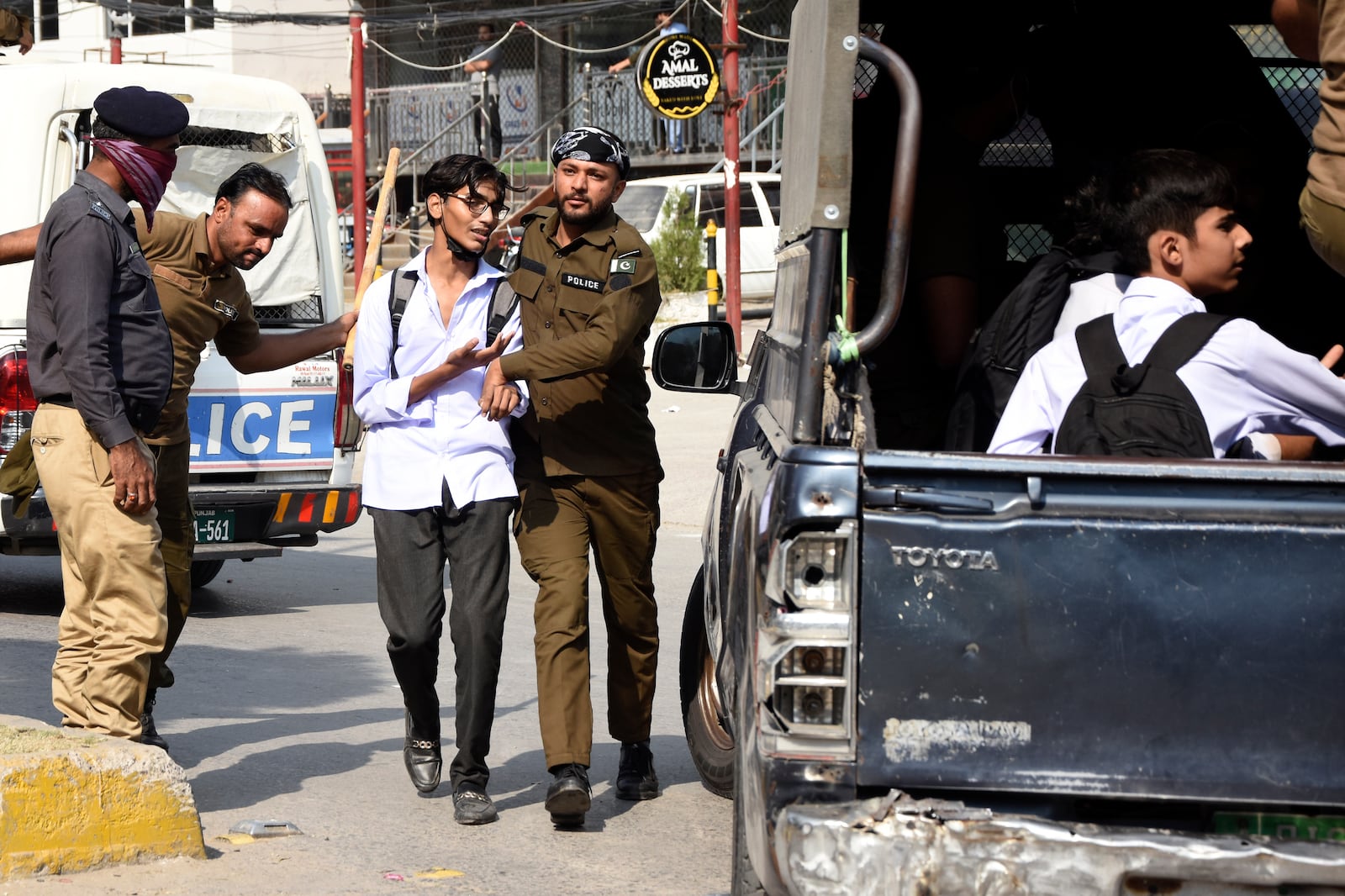 Police officers detain students following a students protest over an alleged on-campus rape in Punjab, in Rawalpindi, Pakistan, Thursday, Oct. 17, 2024. (AP Photo/W.K. Yousafzai)