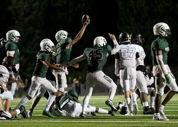 Kennesaw Mountain defensive players signal a turnover after Sprayberry fumbled the ball in the second half of play at Kennesaw Mountain High School Friday, Sept. 10, 2021. (Daniel Varnado/For the AJC)