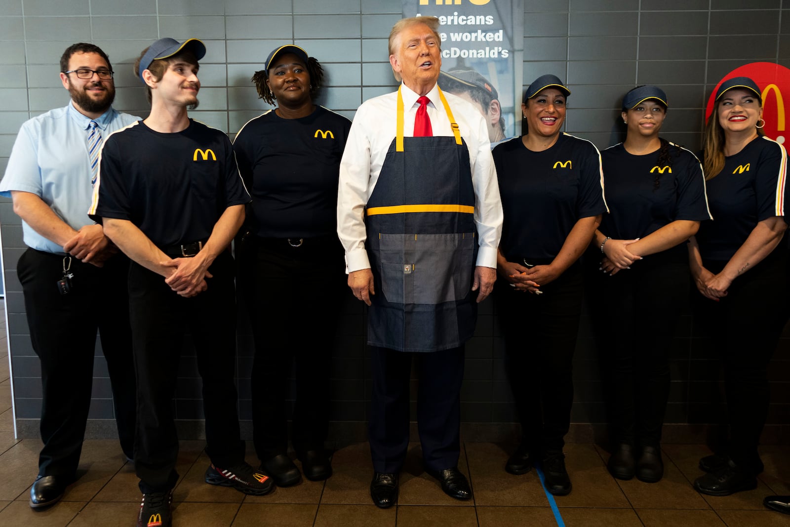 Republican presidential nominee former President Donald Trump poses with employees during a campaign stop at a McDonald's in Feasterville-Trevose, Pa., Sunday, Oct. 20, 2024. (Doug Mills/The New York Times via AP, Pool)