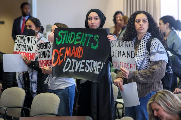 A group of students and alumni of institutions in the University System of Georgia perform a silent sit-in during the state Board of Regents meeting on Tuesday, Jan. 14, 2025, in Atlanta. The protest was organized by Georgia Tech Alumni for Palestine. (Jason Getz/AJC)