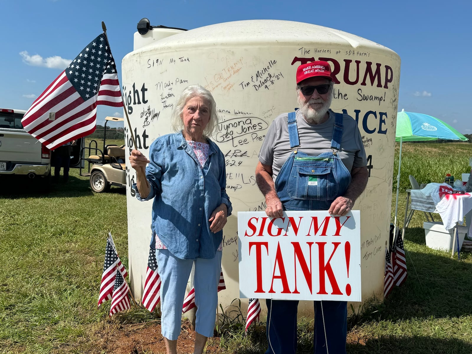 Alfred Hudson, right, and his wife, Sybil, pose in front of their water tank in Webster County, Georgia.