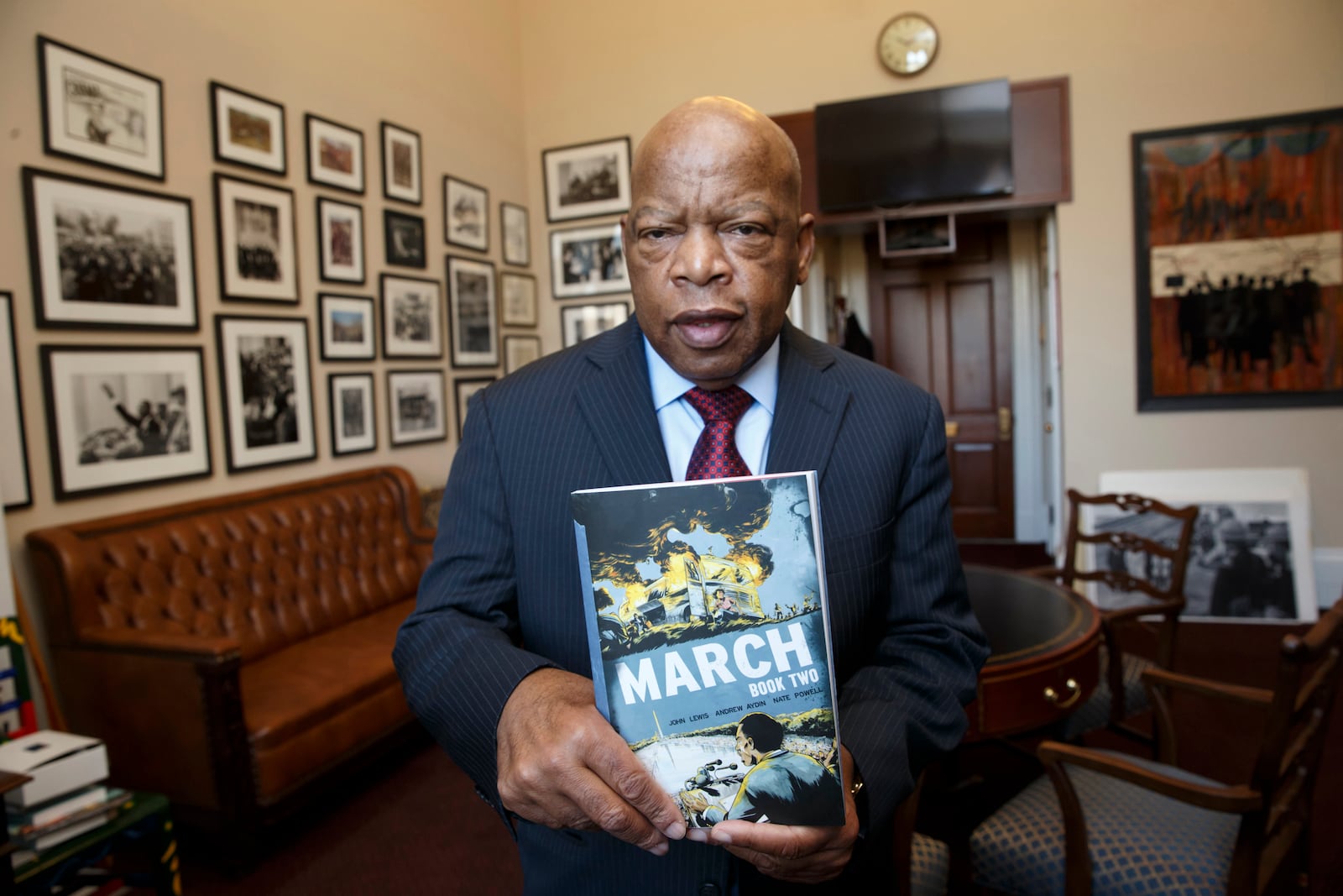 In 2013, John Lewis became a comic book author with the publication of "MARCH: Book One," the first of a three-part autobiography of his time in the civil rights movement. Parts Two (pictured) and Three were published in 2015 and 2016, respectively. The graphic novels were co-written by Andrew Aydin and illustrated by Nate Powell. Among the trilogy's many awards, Part Three won a National Book Award for young people's literature. (J. Scott Applewhite / AP)