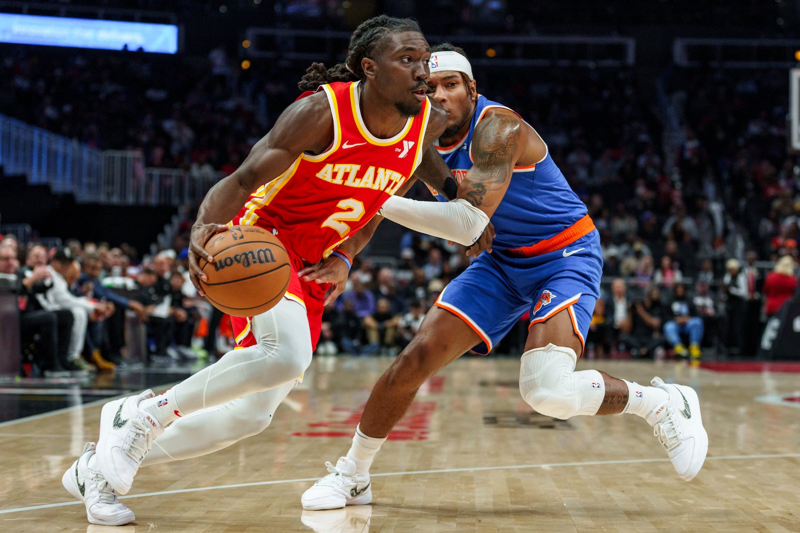 Atlanta Hawks guard Keaton Wallace (2) drives the baseline while guarded by New York Knicks guard Jalen Brunson, right, during the first half of an NBA basketball game, Wednesday, Nov. 6, 2024, in Atlanta. (AP Photo/Jason Allen)