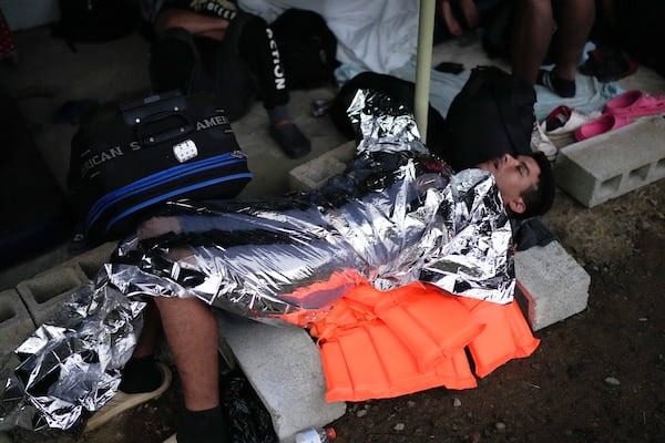 A Venezuelan migrant sleeps in Puerto Cartí, Panama's Caribbean coast, Sunday, Feb. 23, 2025, where he plans to board a boat to Colombia after turning back from southern Mexico where he gave up hopes of reaching the U.S. amid President Trump's crackdown on migration. (AP Photo/Matias Delacroix)