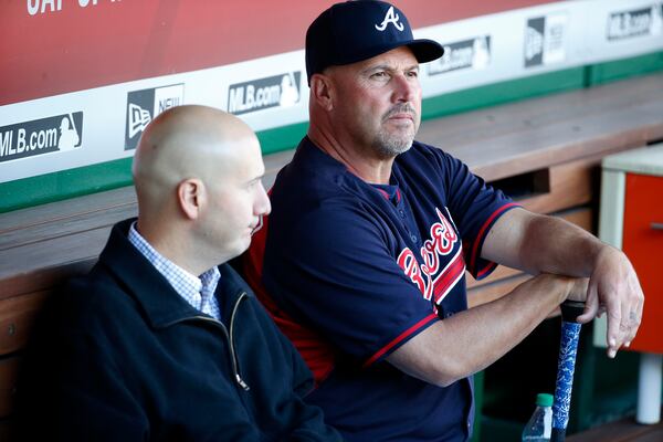 Atlanta Braves general manager John Coppolella, left, sits with manager Fredi Gonzalez, before speaking with the media, before a baseball game against the Washington Nationals at Nationals Park, Wednesday, April 13, 2016, in Washington. Braves outfielder Hector Olivera was placed on paid administrative leave by Major League Baseball after he was arrested when a woman accused him of assault at a hotel outside Washington. (AP Photo/Alex Brandon)