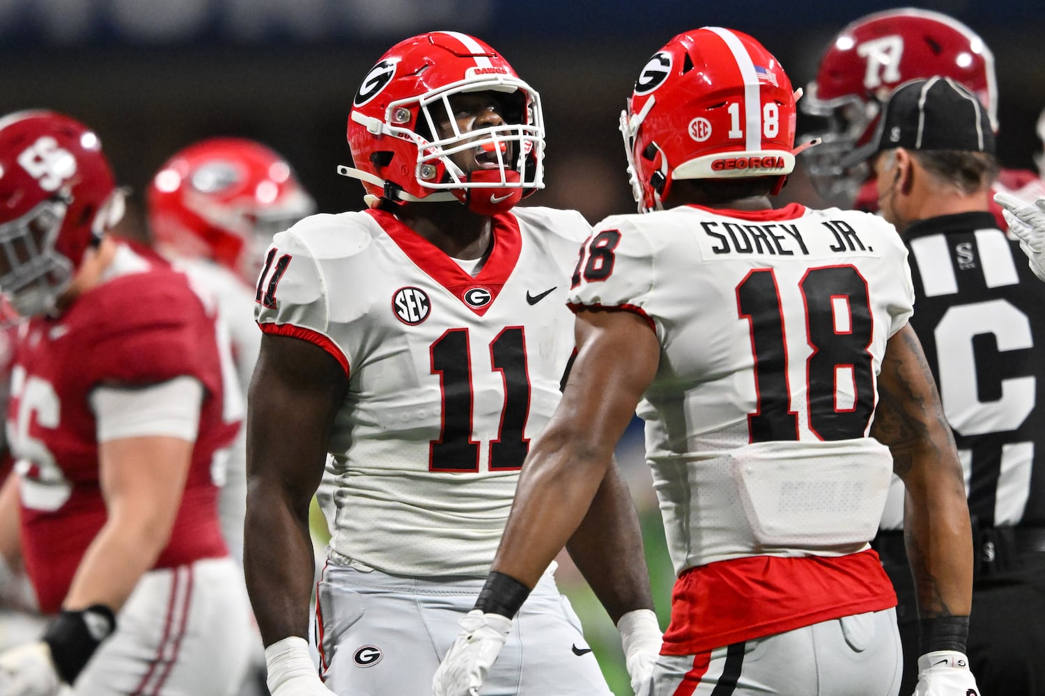 Georgia Bulldogs linebacker Jalon Walker (11) celebrates with Xavian Sorey Jr. (18) after tackling Alabama Crimson Tide quarterback Jalen Milroe during the first half of the SEC Championship football game at the Mercedes-Benz Stadium in Atlanta, on Saturday, December 2, 2023. (Hyosub Shin / Hyosub.Shin@ajc.com)