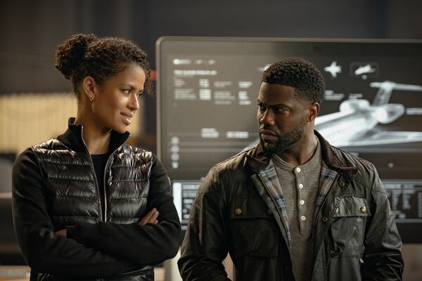 Gugu Mbatha Raw (left) plays an Interpol agent who seeks out professional thief and former love interest Kevin Hart and his crew to steal $500 million in gold from an aircraft 40,000 feet in the air for Netflix's "Lift." Christopher Barr/Netflix