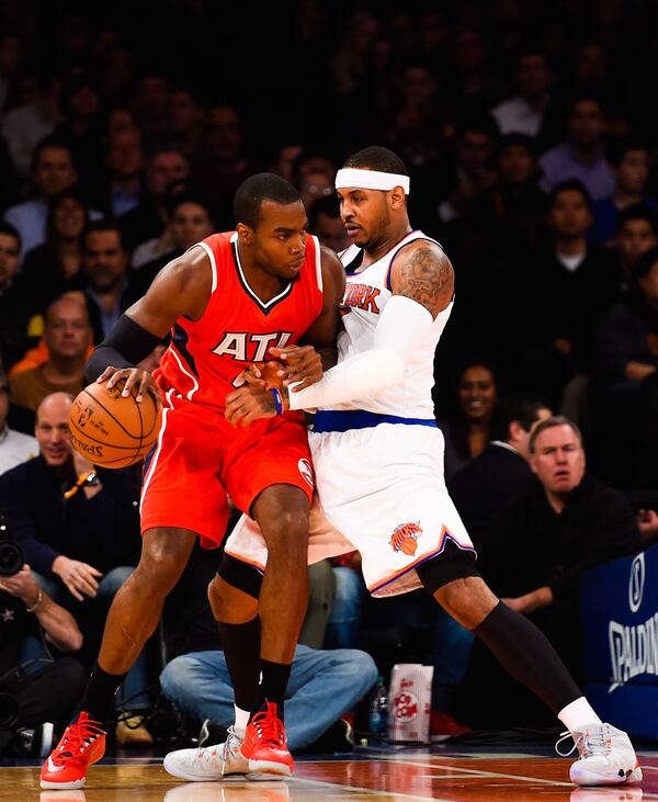 NEW YORK, NY - NOVEMBER 10: Carmelo Anthony #7 of the New York Knicks guards Paul Millsap #4 of the Atlanta Hawks in the first half at Madison Square Garden on November 10, 2014 in New York City. NOTE TO USER: User expressly acknowledges and agrees that, by downloading and/or using this photograph, user is consenting to the terms and conditions of the Getty Images License Agreement. (Photo by Alex Goodlett/Getty Images)