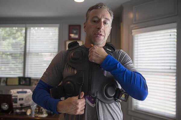 Andy Lipman uses his airway clearance vest system during his afternoon treatment at his home in Sandy Springs. Andy has cystic fibrosis, an inherited disorder that causes severe damage to the lungs, digestive system and other organs in the body. The Monarch Airway Clearance System helps clear the mucus from his lungs. ALYSSA POINTER / ALYSSA.POINTER@AJC.COM